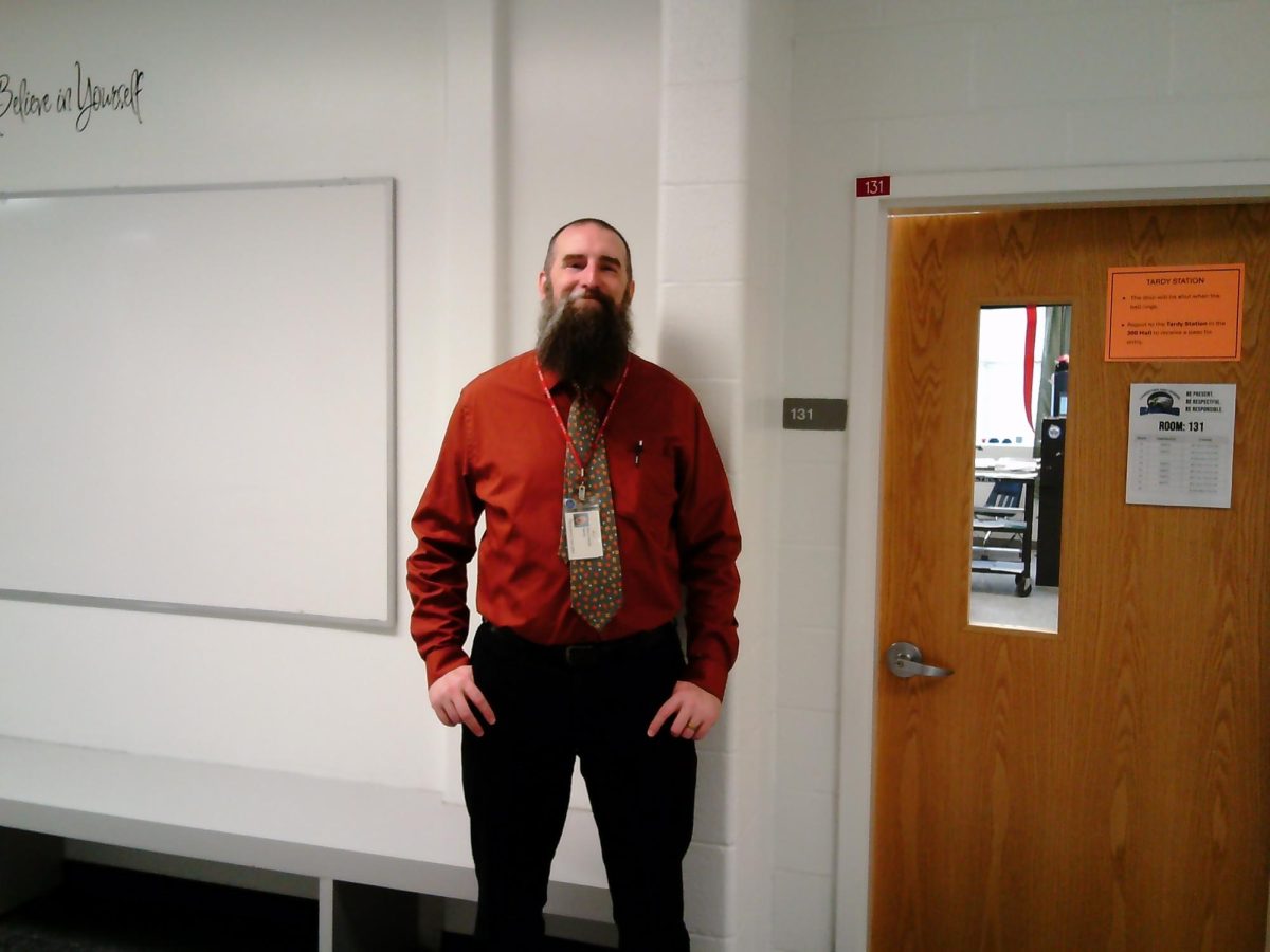 Mr. Smith outside of his classroom in room 131.